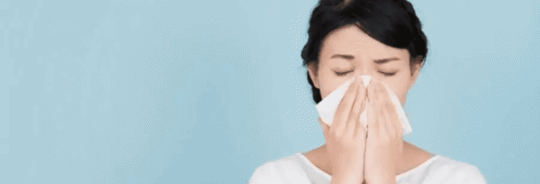woman blowing nose