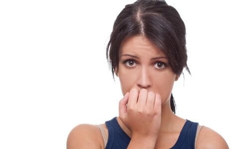 woman biting finger nails