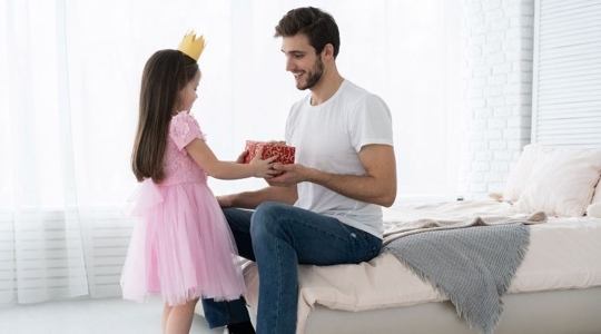 father and daughter with gift