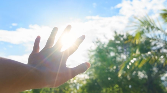 hand covering sun outside